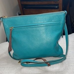 This is a teal fossil purse very stylish and beautiful